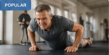 Adult doing push-ups in a gym.